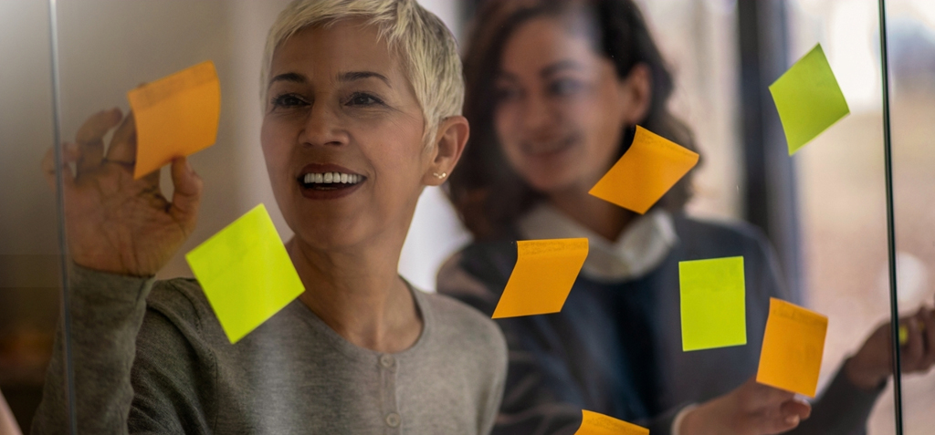business partners with sticky notes