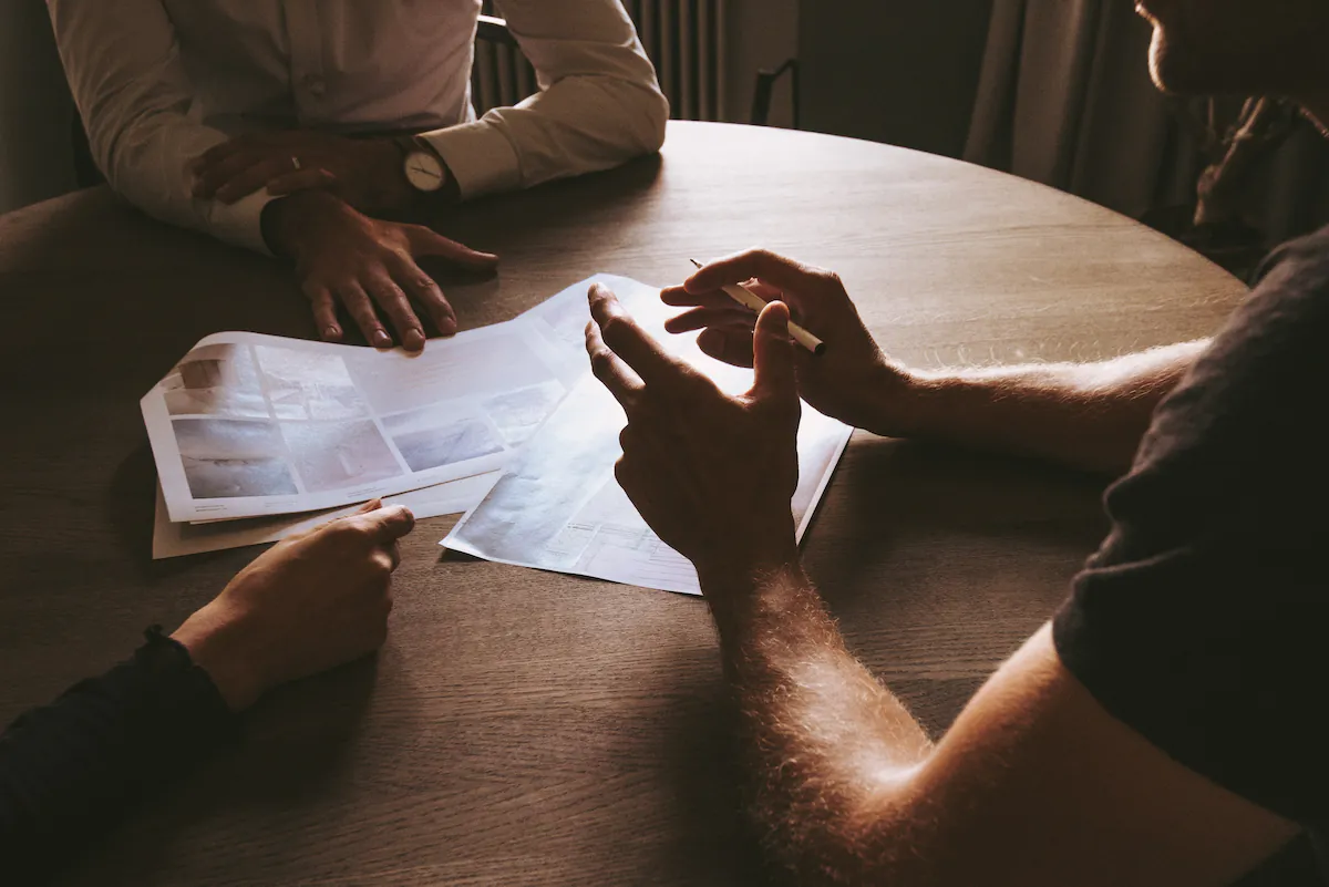 Business partners discussing around table dark