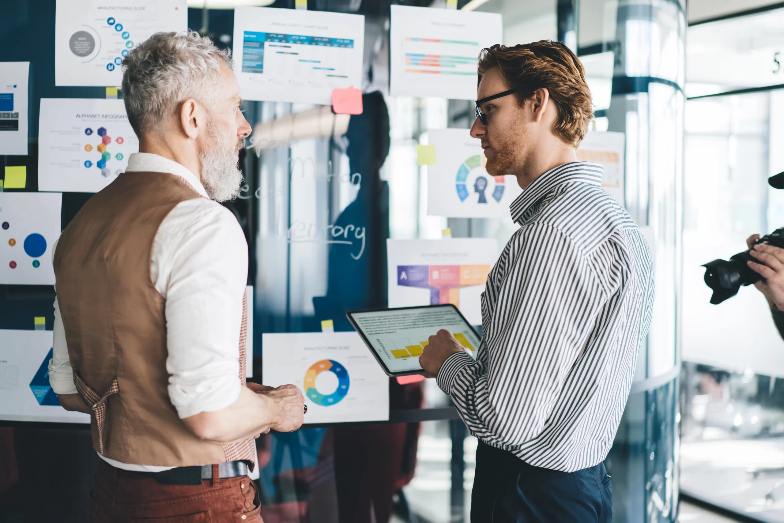 older and younger business partners plan
