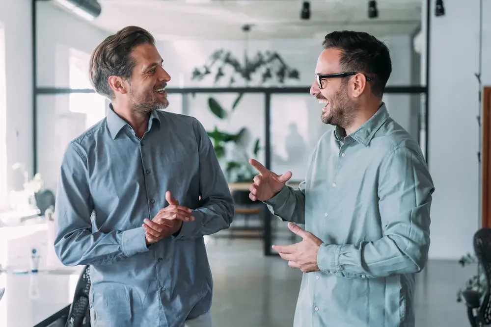business-partners-in-animated-discussion Two business partners talking animatedly in an office