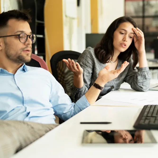 frustrated-business-partners-reviewing-laptop-at-desk frustrated-business-partners-reviewing-laptop-at-desk