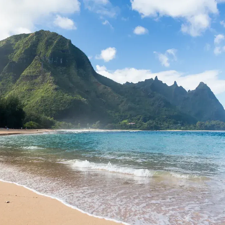 Tunnels Beach on the north shore of Kauai, with green mountains behind the bay